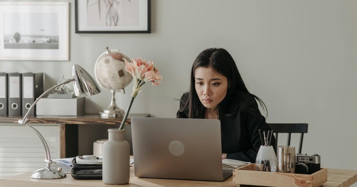 A lady looking at her laptop which might be in search for a job