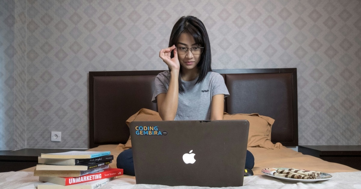 A woman working at the comfort of her home showing the she has time management strategy